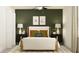 Bedroom with a full bed, green accent wall, and modern decor at 17638 Happytrails St, Land O Lakes, FL 34638