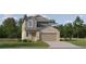 Two-story house with gray and beige siding, two-car garage, and landscaping at 17638 Happytrails St, Land O Lakes, FL 34638