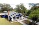 Blue house with gray roof, white trim, and a porch, showcasing curb appeal at 1815 2Nd E Ave, Bradenton, FL 34208