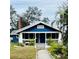 Charming blue house with a porch and well-maintained landscaping at 1815 2Nd E Ave, Bradenton, FL 34208