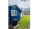 Side view of the house showcasing the blue exterior and landscaping at 1815 2Nd E Ave, Bradenton, FL 34208