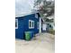 View of the home's side, highlighting its blue siding and landscaping at 1815 2Nd E Ave, Bradenton, FL 34208