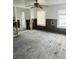 A living room with exposed floorboards and damaged walls at 1815 2Nd E Ave, Bradenton, FL 34208