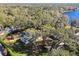 Aerial view showcasing multiple houses and a lake at 18803 15Th St, Lutz, FL 33549