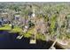 Aerial view showcasing a house near the lake with surrounding lush greenery at 18803 15Th St, Lutz, FL 33549