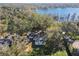 Aerial view of a house near a lake with lush trees at 18803 15Th St, Lutz, FL 33549