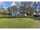 Large backyard with playground and house view at 18803 15Th St, Lutz, FL 33549