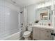 Clean bathroom with subway tile, updated vanity, and a shower/tub combo at 18803 15Th St, Lutz, FL 33549