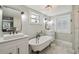 Elegant bathroom with a clawfoot tub and marble flooring at 18803 15Th St, Lutz, FL 33549