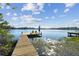 Wooden dock extending into lake with 2 yellow chairs at 18803 15Th St, Lutz, FL 33549