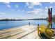 Serene waterfront dock with yellow chairs, offering picturesque lake views at 18803 15Th St, Lutz, FL 33549