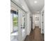 Hallway with hardwood floors and French doors leading to the backyard at 18803 15Th St, Lutz, FL 33549