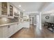 Modern kitchen with white cabinets, gray backsplash and stainless steel appliances at 18803 15Th St, Lutz, FL 33549