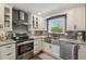 Modern kitchen with stainless steel appliances and a farmhouse sink at 18803 15Th St, Lutz, FL 33549