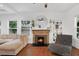 Living room with a cozy brick fireplace and hardwood floors at 207 E Selma Ave, Tampa, FL 33603