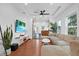 Living room with hardwood floors, sectional sofa, and a view into the kitchen at 207 E Selma Ave, Tampa, FL 33603