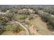 Aerial view of property showing home, pond, and pasture at 3009 Jim Johnson Rd, Plant City, FL 33566