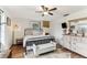 Comfortable bedroom with a metal bed frame, dresser, and hardwood floors at 3009 Jim Johnson Rd, Plant City, FL 33566