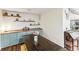 Charming dining area with rustic wood table and light blue cabinets at 3009 Jim Johnson Rd, Plant City, FL 33566