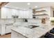 Modern kitchen with white cabinets, granite counters, and farmhouse sink at 3009 Jim Johnson Rd, Plant City, FL 33566