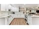 Modern kitchen with white cabinets, granite counters, and farmhouse sink at 3009 Jim Johnson Rd, Plant City, FL 33566