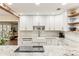 Modern kitchen with white cabinets, granite counters, and farmhouse sink at 3009 Jim Johnson Rd, Plant City, FL 33566