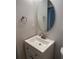 Bathroom with white vanity, oval mirror, and brushed nickel fixtures at 306 S Habana Ave # 7, Tampa, FL 33609