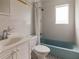 Clean bathroom with white tile, shower/tub combo, and vanity at 316 W Genesee St, Tampa, FL 33603