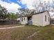 Side view of the house showcasing a fenced yard and driveway at 316 W Genesee St, Tampa, FL 33603