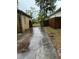 Backyard view with wet driveway and fence at 3504 E 22Nd Ave, Tampa, FL 33605