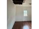 Bedroom with wood-look floors, window, and ceiling damage at 3504 E 22Nd Ave, Tampa, FL 33605