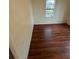 Empty bedroom with wood-look floors and window at 3504 E 22Nd Ave, Tampa, FL 33605