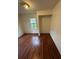 Simple bedroom with wood-look floors and window at 3504 E 22Nd Ave, Tampa, FL 33605