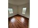 Bedroom with hardwood floors and two windows at 3504 E 22Nd Ave, Tampa, FL 33605