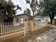 House exterior with white fence and palm tree at 3504 E 22Nd Ave, Tampa, FL 33605