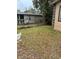 Small side yard with grass and neighboring house at 3504 E 22Nd Ave, Tampa, FL 33605