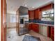 Stainless steel appliances and wood cabinetry in this kitchen at 407 Bay View St, Safety Harbor, FL 34695