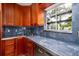 Kitchen with blue granite countertops and wood cabinets at 407 Bay View St, Safety Harbor, FL 34695