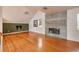 Living room with hardwood floors, fireplace, and access to a balcony at 407 Bay View St, Safety Harbor, FL 34695