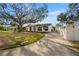 Single-story home with a large oak tree and spacious front yard at 431 Rafael Ne Blvd, St Petersburg, FL 33704