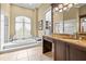 Elegant bathroom with soaking tub and granite vanity at 4339 Cheval Blvd, Lutz, FL 33558