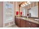 Bathroom with granite vanity and red striped wallpaper at 4339 Cheval Blvd, Lutz, FL 33558