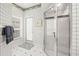 Bathroom with shower, door to exterior, and tiled flooring at 4339 Cheval Blvd, Lutz, FL 33558