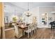 Elegant dining room features a large table, chandelier, and hardwood floors at 4339 Cheval Blvd, Lutz, FL 33558