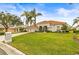 House with a large front yard, palm trees, and a driveway at 4339 Cheval Blvd, Lutz, FL 33558