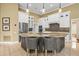 Modern kitchen with granite countertops, stainless steel appliances, and large island at 4339 Cheval Blvd, Lutz, FL 33558