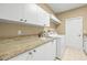 Laundry room with granite countertop and white cabinets at 4339 Cheval Blvd, Lutz, FL 33558