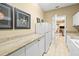 Laundry room with granite countertop, white cabinets and refrigerator at 4339 Cheval Blvd, Lutz, FL 33558