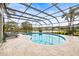 Inviting kidney-shaped pool with screened enclosure at 4339 Cheval Blvd, Lutz, FL 33558