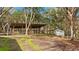 Wooden animal shelter with multiple stalls, located outdoors at 4540 Oakfield Cir, Dade City, FL 33523